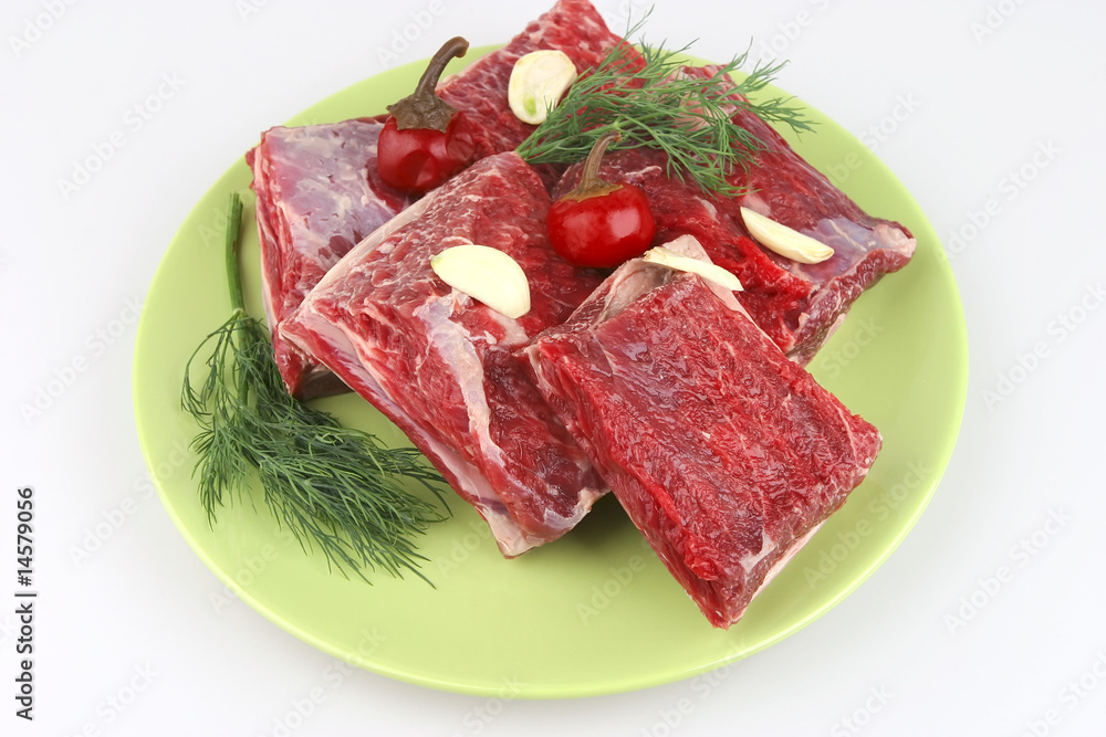 raw ribs on green dish raw ribs on green dish