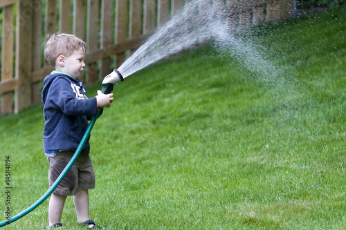 Boy watering garden