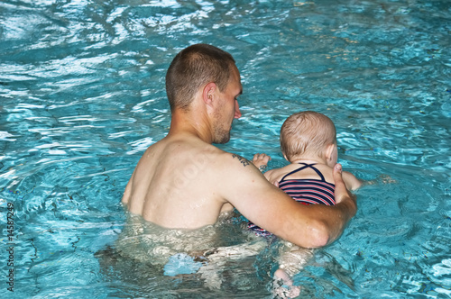 Father with daughter in swimming pool