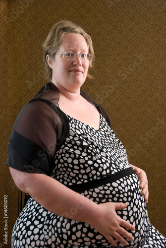 Fotografie Pregnant Woman Tenderly Holding Her Baby