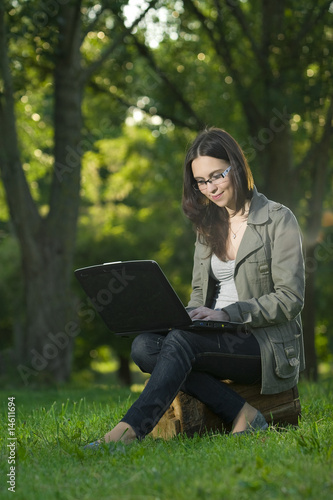 student with laptop outdoors