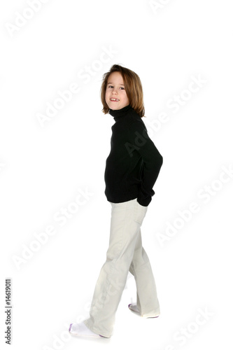 cute girl standing with her hands in her back pockets