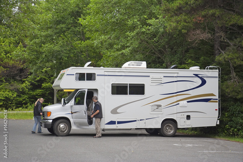 Large Motor Home with Tourists in the Woods