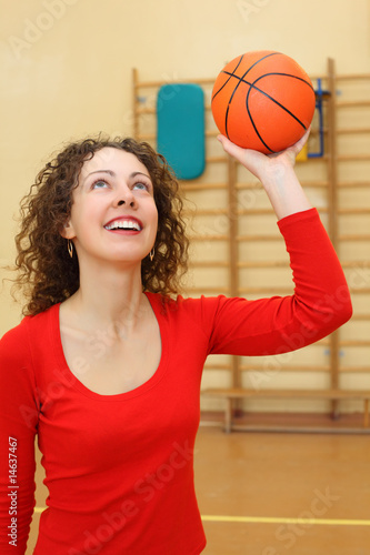 Young girl throws basketball ball