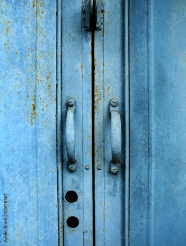 blue metal fence door © Eky Chan