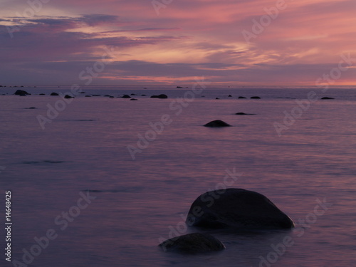 Rocks in sea at dusk