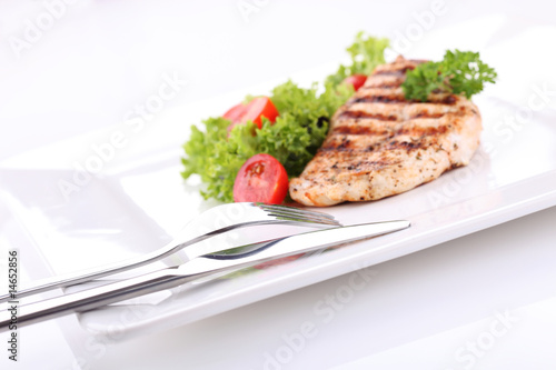 Fototapeta Naklejka Na Ścianę i Meble -  Grilled chicken breasts on a plate with fresh vegetables