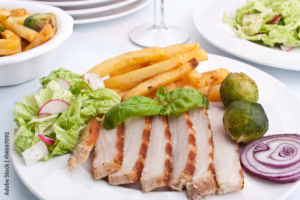 sliced pork chops with fries and brussels sprouts sliced pork chops with fries and brussels sprouts