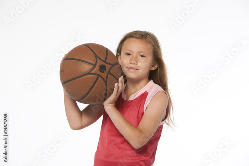 Little girl holding basketball