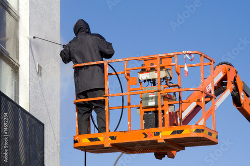 a worker in a cherry-picker