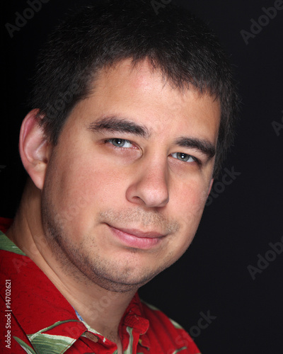 Male portrait on black background with red shirt