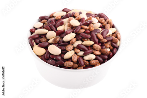 Various bean types in white bowl isolated on white