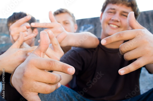 teens doing hand signs
