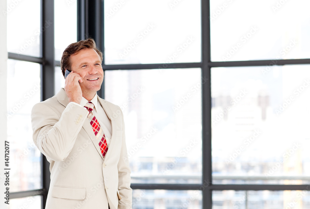 Businessman speaking on a mobile phone with copy-space Businessman speaking on a mobile phone with copy-space