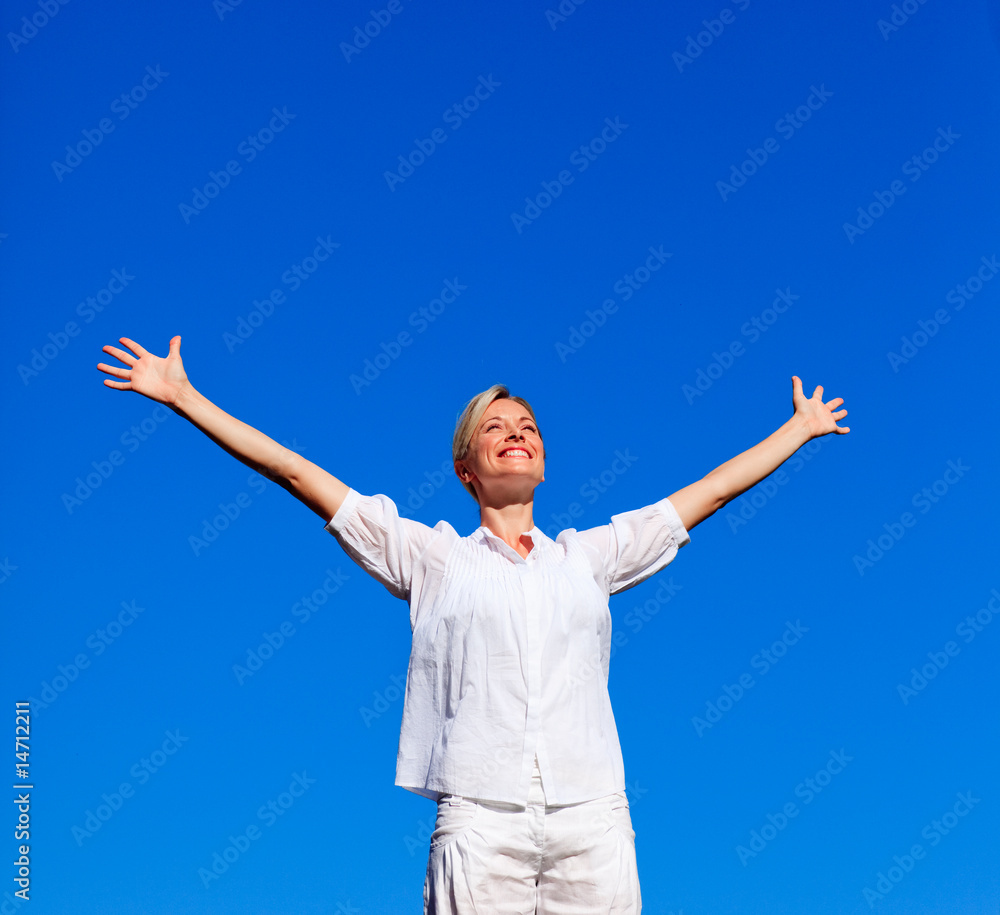 Young woman doing exercises against blue sky Young woman doing exercises against blue sky