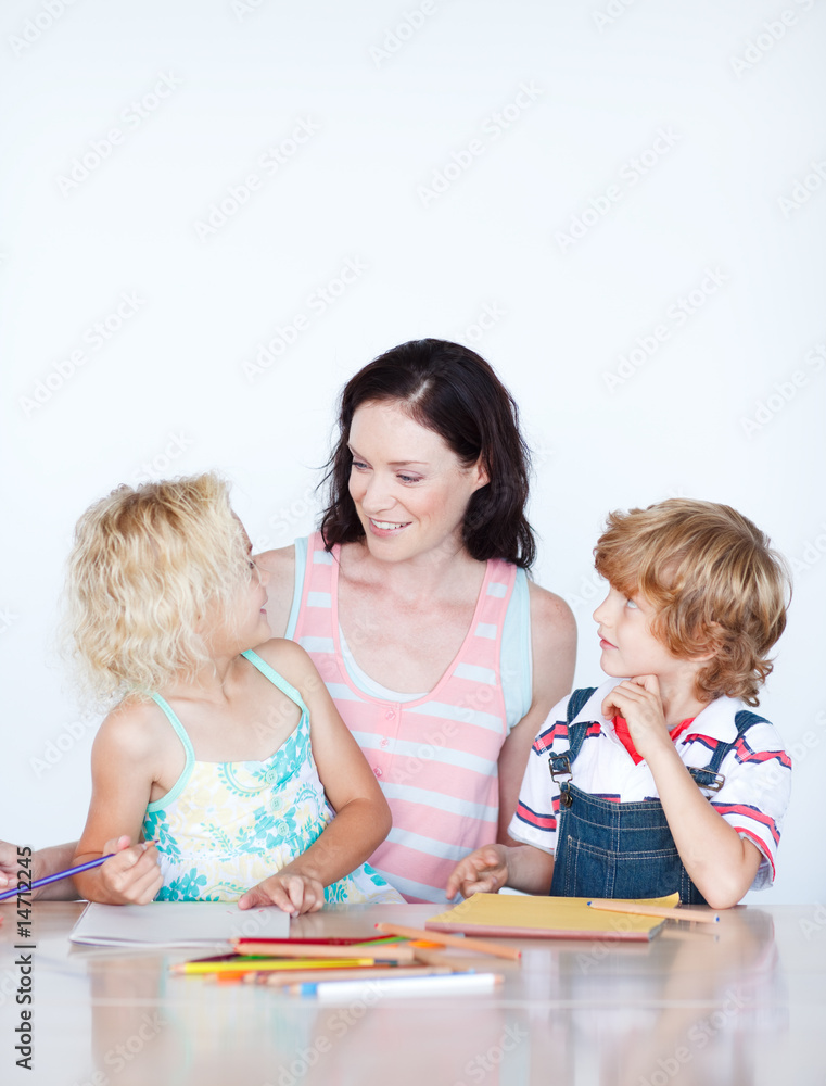 Mother helping her children doing homework Mother helping her children doing homework
