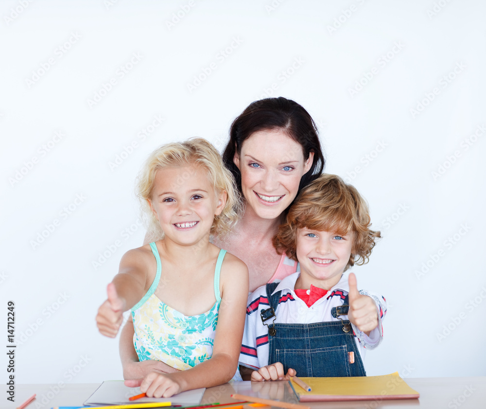 Children doing homework with their mother with thumbs up Children doing homework with their mother with thumbs up
