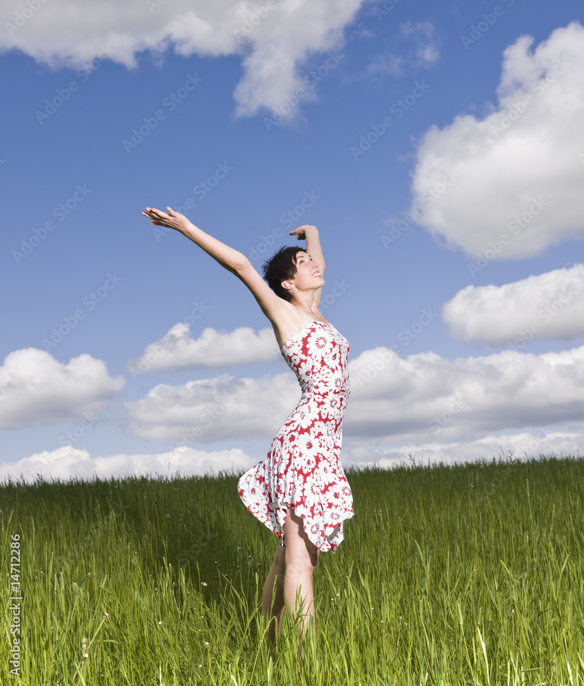 Young woman standing on a field Young woman standing on a field