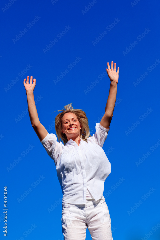 Carefree woman enjoying life against blue sky Carefree woman enjoying life against blue sky