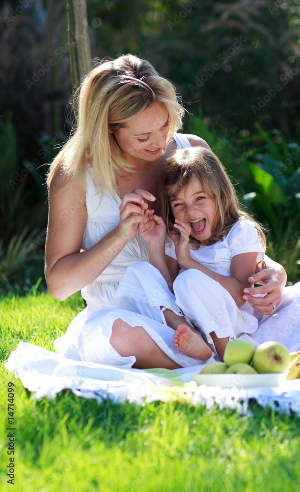 Mother and daughter having fun in a picnic Mother and daughter having fun in a picnic