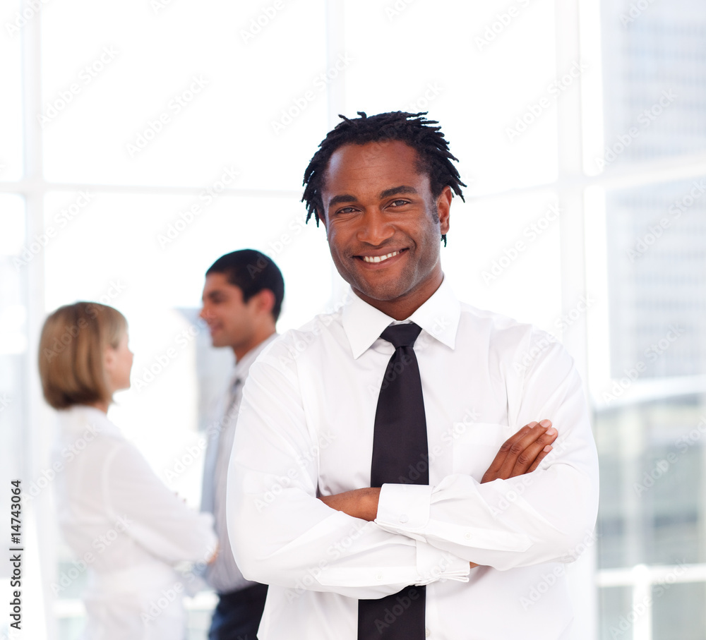 African businessman with folded arms smiling at the camera African businessman with folded arms smiling at the camera