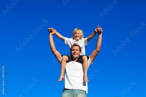 Father giving his son a piggyback ride