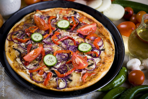 Fresh vegetables with a pizza