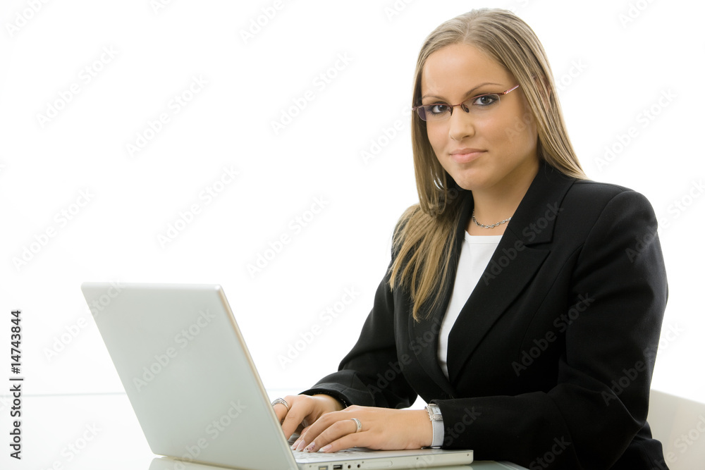 Businesswoman using laptop at desk Businesswoman using laptop at desk