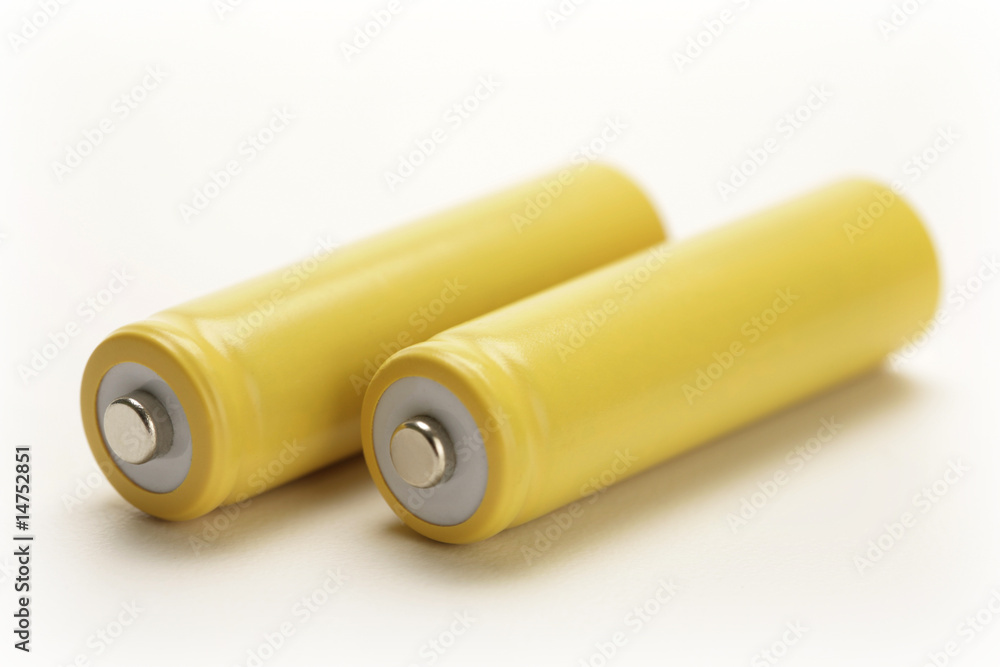 two yellow rechargeable batteries on white background two yellow rechargeable batteries on white background