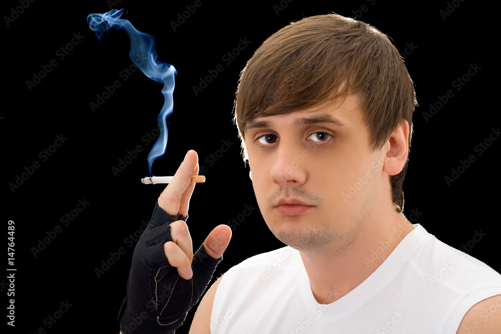 Fototapeta premium Portrait of the young man with a cigarette. Isolated