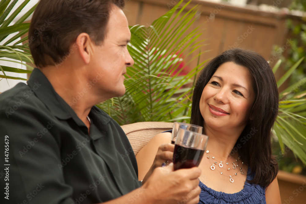 Attractive Hispanic and Caucasian Couple Drinking Wine Attractive Hispanic and Caucasian Couple Drinking Wine