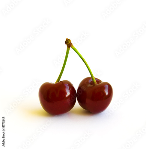 two berries of ripe cherry on a white background