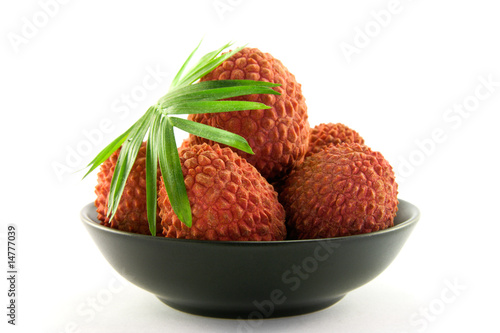 Lychee in a Black Dish with Leaf photo