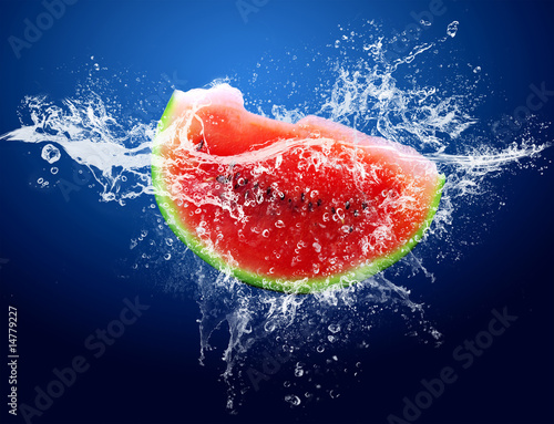 Water drops around watermelon on blue background