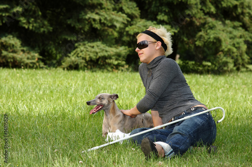 blind woman playing with her dog photo