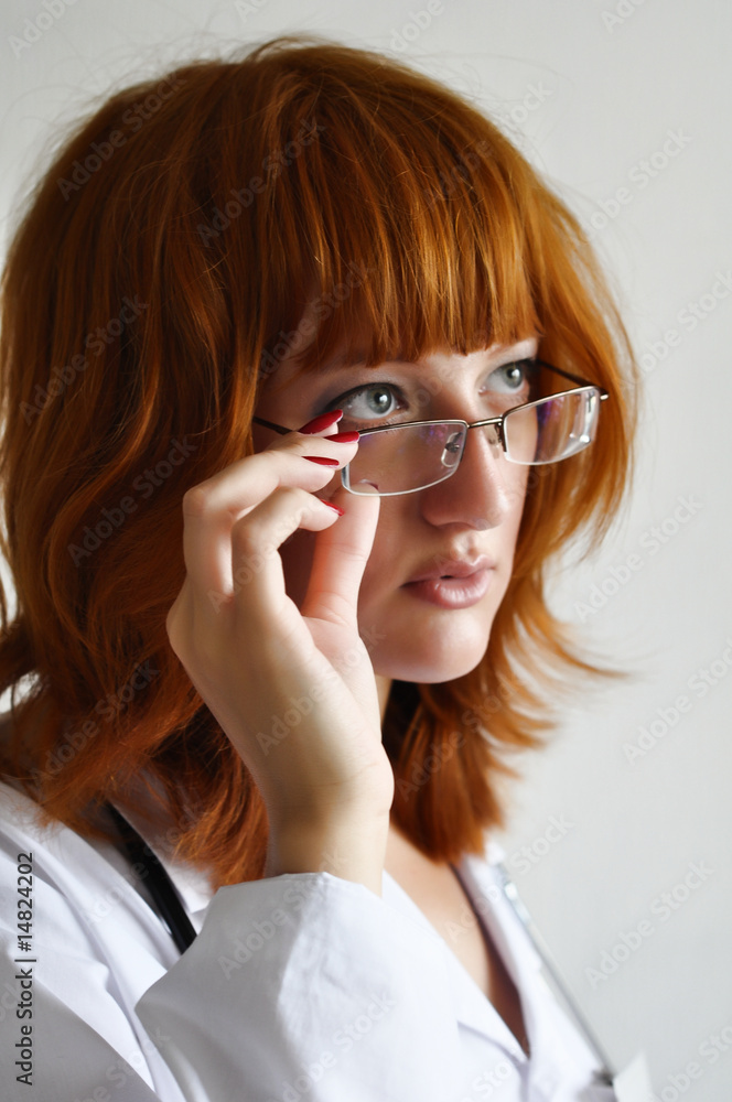 Female doctor looking over glasses with astonishment