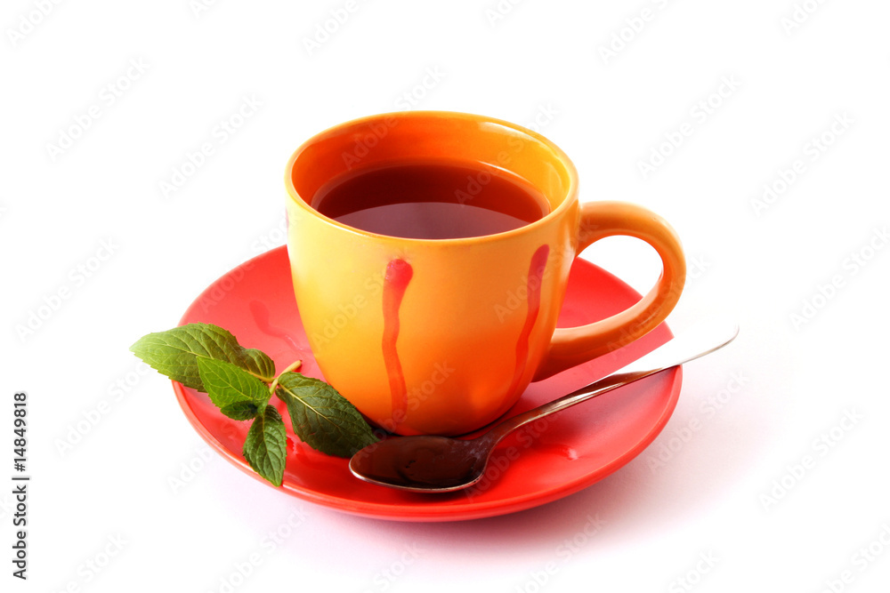 Cup of green tea on the saucer with mint Cup of green tea on the saucer with mint