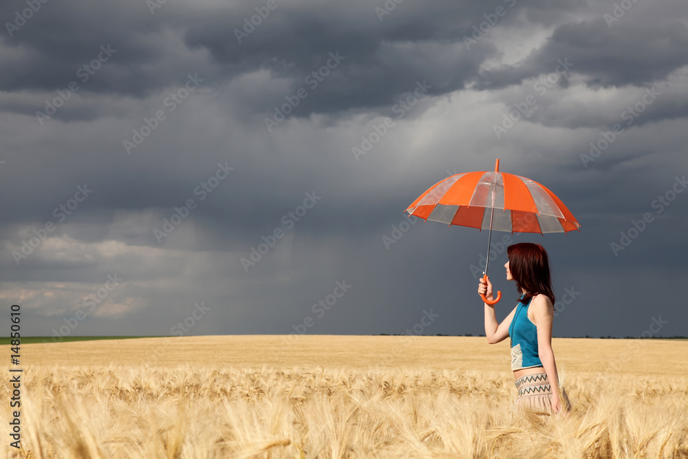 girl with umbrella at wheat field in rainy day girl with umbrella at wheat field in rainy day