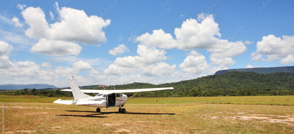 Cessna plane on the unpaved airfield Cessna plane on the unpaved airfield