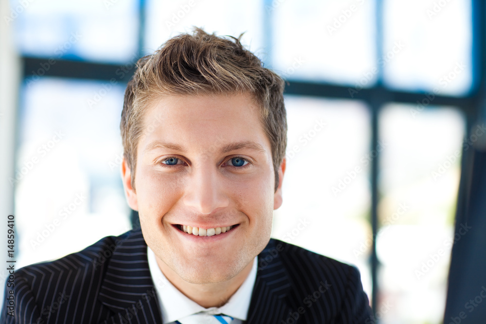 Attractive businessman smiling at the camera Attractive businessman smiling at the camera