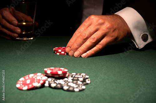 Card player in casino with chips