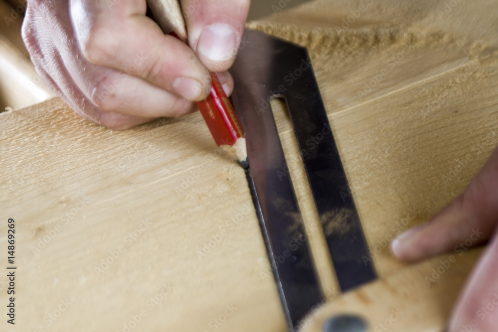 worker drawing on wood plank