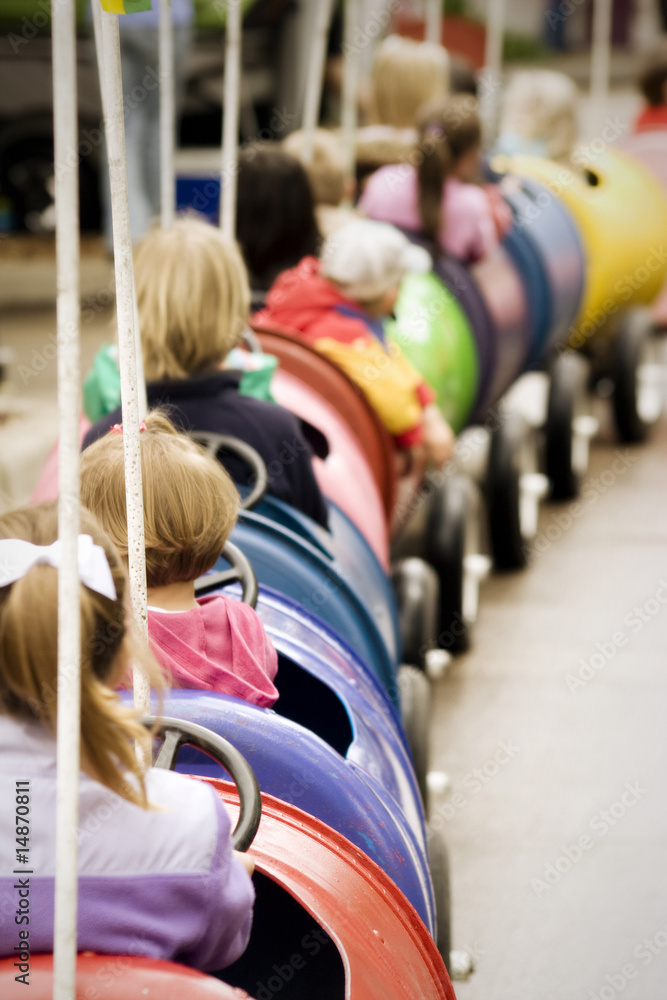 Kids on amusement park train ride