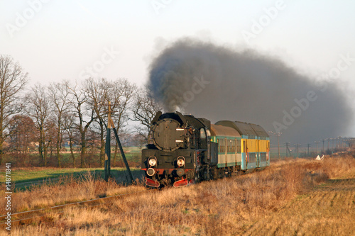Old retro steam train passing the countryside