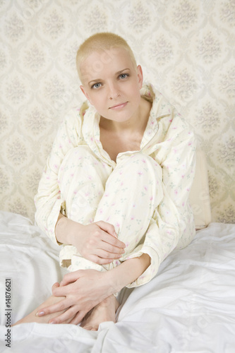 short hair young woman sitting on bed