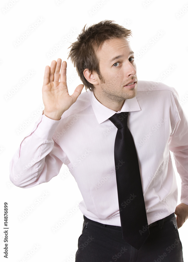 Young business man cupping hand behind ear on white background Young business man cupping hand behind ear on white background
