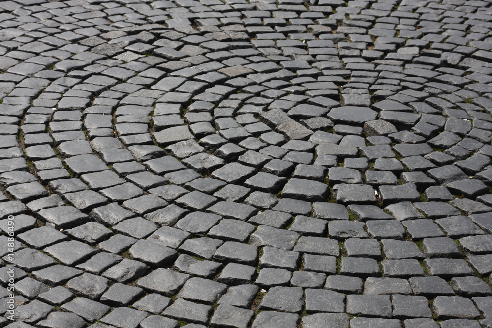 Old medieval granite cobble road background texture