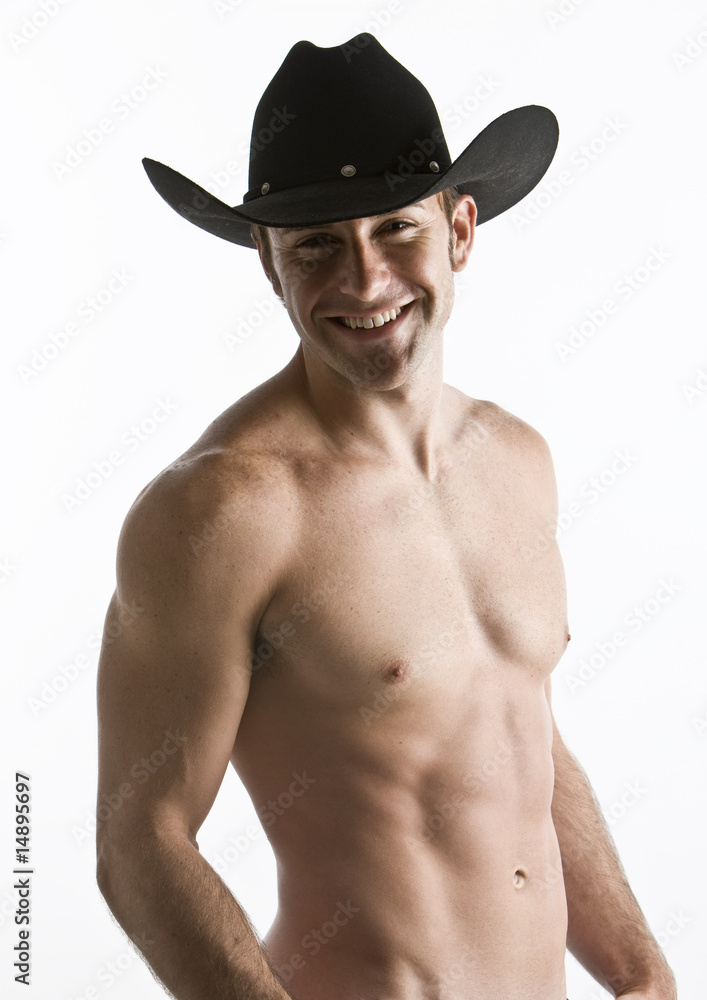 An attractive cowboy with his shirt off in studio An attractive cowboy with his shirt off in studio