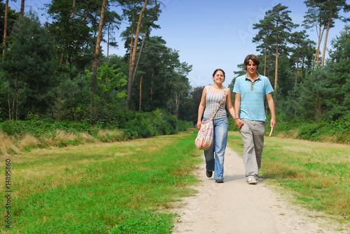 young couple walking in the forest