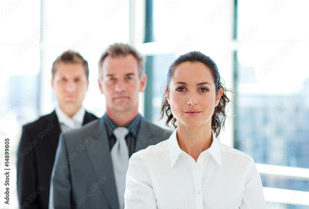 Serious businesswoman in front of her team Serious businesswoman in front of her team